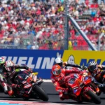 Marco Bezzecchi and Marc Marquez, with other riders, racing at the 2025 Hungary GP